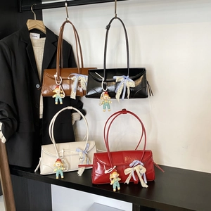 Set of four glossy leather tote bags in various colors with cute bow and doll charms