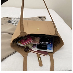 Close-up of khaki leather tote bag interior showing large capacity for daily essentials