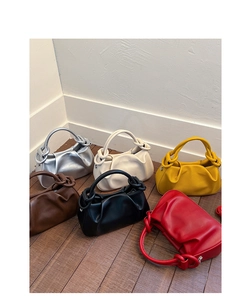Collection of stylish pleated crossbody bags in six vibrant colors on wooden floor