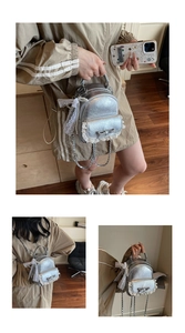 Detailed view of silver pleated leather mini backpack with lace edges and bow detail