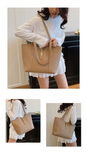 Detail of khaki tote bag showing textured litchi grain leather and gold metal twist lock