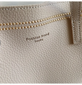 Detailed macro view of beige lychee leather texture with Fashion trend embossing and stitching