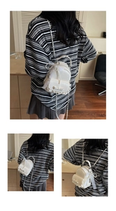 Detail of white mini lace backpack with pearl chain and bow decoration for women