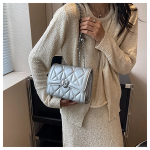 Détail du sac à chaîne matelassé argenté avec fermoir coeur métallique et finition brillante