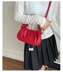 Fashionable red pleated handbag with knotted handle and adjustable strap for crossbody wear