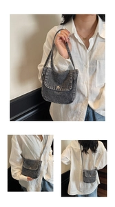 Macro view of retro denim messenger bag featuring metal buckle and washed fabric detail