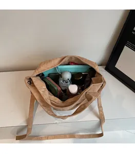Spacious interior of the brown tote bag showing umbrella, tablet and daily essentials