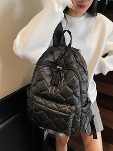 Quilted black puffer backpack for women featuring heart pattern stitching and adjustable straps