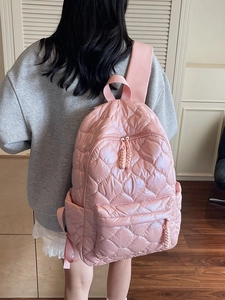 Pink quilted down nylon backpack with diamond pattern and woven zipper details for women