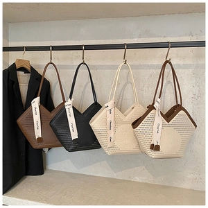 Detail of trendy hollow-out tote bags with V-shaped opening and decorative silk scarf
