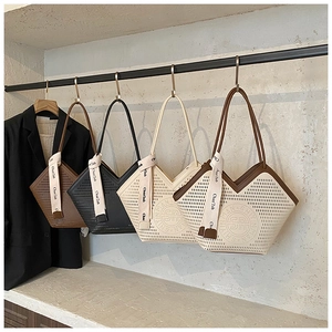 Detailed laser-cut hollow patterns on tote bags with decorative logo and silk ribbons