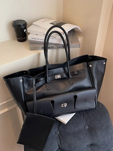 Large black leather tote bag with multiple pockets and detachable pouch for daily commute