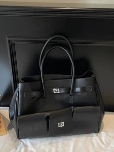 Large black tote bag with silver twist-lock pockets and spacious dual-handle design