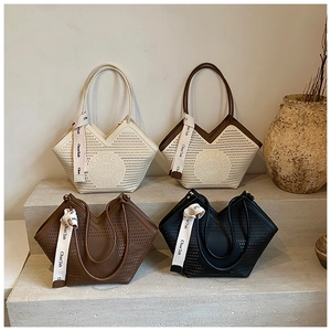 Detailed display of four tote bags featuring laser-cut perforated leather and logo straps