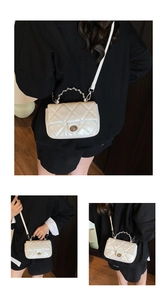 Detailed views of beige quilted crossbody bag with metal chain handle and twist lock