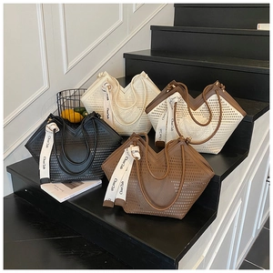 Detail of laser-cut tote bags in multiple colors with stylish woven strap handles