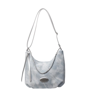 Light blue washed canvas hobo bag with silver chain and fringe details in minimalist style