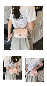 Close-up of pink quilted patent leather bag with metal chain handle and twist lock detail