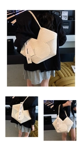 Detail of laser-cut cream tote bag with stylish wide canvas strap and V-neckline shape
