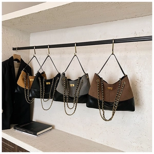 Detail view of four contrast color quilted shoulder bags with gold chain straps and twist locks
