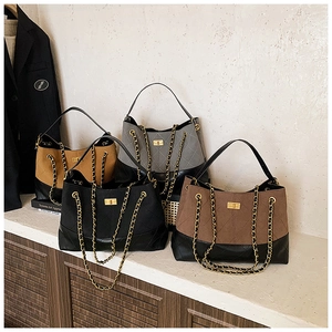 Group of quilted chain shoulder bags in black, brown, and grey with gold twist locks