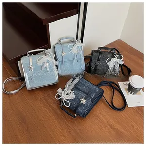 Detail showing multi-color sequin tweed backpacks with pearl bow charms and stars