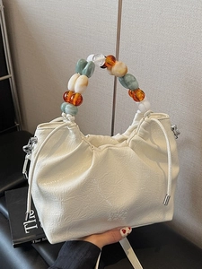 White ruched bucket bag with colorful pearl handle and enjoy every day embossing
