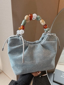 Light blue denim bucket bag with sparkling rhinestones and colorful beaded handle