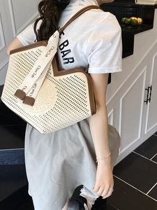 Chic cream cutout tote bag with brown leather trim and wide strap for daily commute