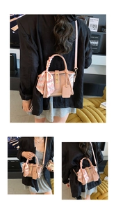 Detail of pink transparent PVC bucket bag with silk scarf handle and gold buckle hardware
