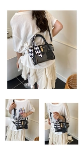 Detail of black transparent PVC bucket bag with checkered scarf and detachable strap