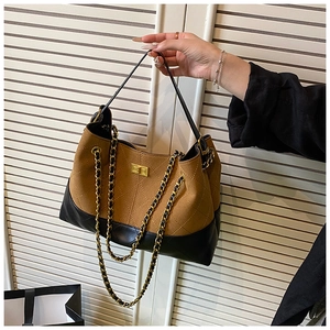 Detail of contrast stitching and diamond-quilted pattern with golden twist lock