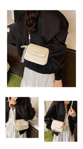Detail of cream leather crossbody bag with lace charms and fashion letter print
