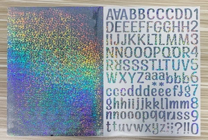 Detail of holographic laser DIY stickers showing alphabet letters and numbers on wood
