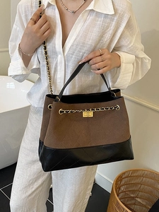 Retro two-tone tote bag with diamond stitching, gold chain strap, and contrast leather panels