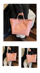 Close-up of pink tote bag with crinkle texture showing the large capacity and text detail