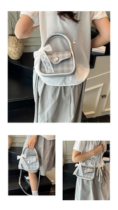 Detail of silver checkered handbag with elegant white lace bow and metal handle