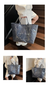 Detail of grey-blue PVC tote bag with waterproof glossy finish and TOTE BAG print