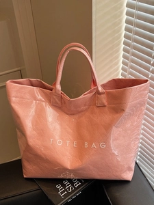 Pink waterproof tote bag with crinkled texture and TOTE BAG print for daily use