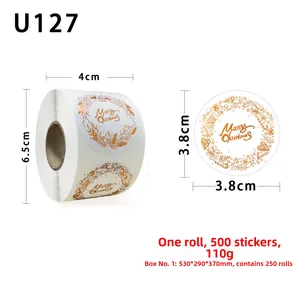 Detail of 3.8cm gold Merry Christmas stickers showing roll size and festive wreath designs