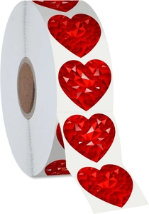 Macro shot of 2.5cm red heart laser stickers with geometric crystal texture on a roll
