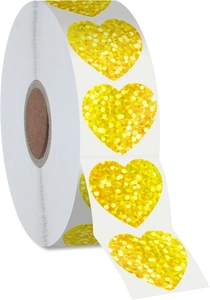 Close-up of golden heart glitter stickers on a roll for decorative gift labeling