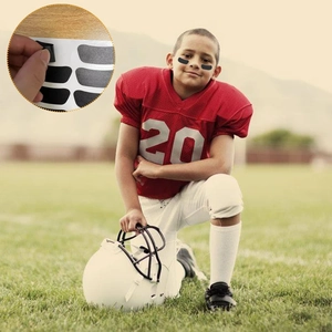 Matte black eye black stickers for sports to reduce glare on field during football or baseball