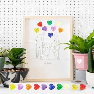 Close-up of glitter heart stickers with Love Forever illustration on a wood frame