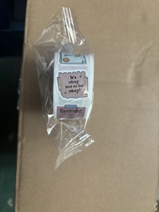 Macro shot of roll of self-adhesive motivational labels with inspirational quotes