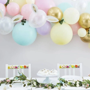 Easter party decoration set with pastel balloon arch and floral dining chair accents