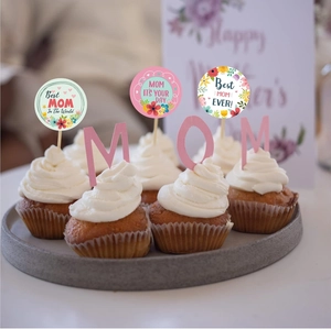 Detailed close-up of floral Mother's Day cupcake toppers and pink MOM letter inserts