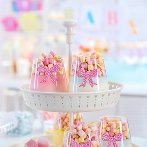 Pink glitter bow stickers on glassware for festive party table decoration and baby shower
