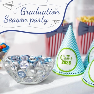 Close-up of Class of 2025 party hats and matching blue wrapped graduation chocolates
