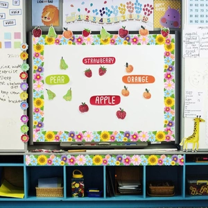 Classroom decoration kit featuring sunflower borders and colorful fruit cutouts on a white board